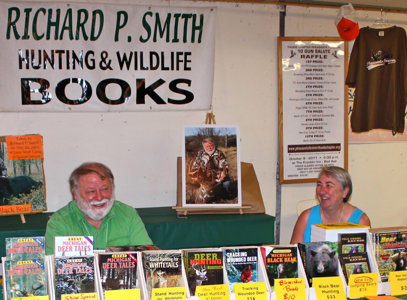 Richard P. Smith and wife Lucy LaFaive in their booth selling Richard’s whitetail deer, black bear, hunting and wildlife books and DVDs at Woods-N-Water Outdoor Weekend in Imlay City, MI